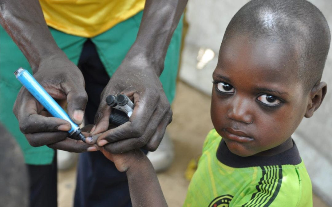 Child’s finger marked to indicate being