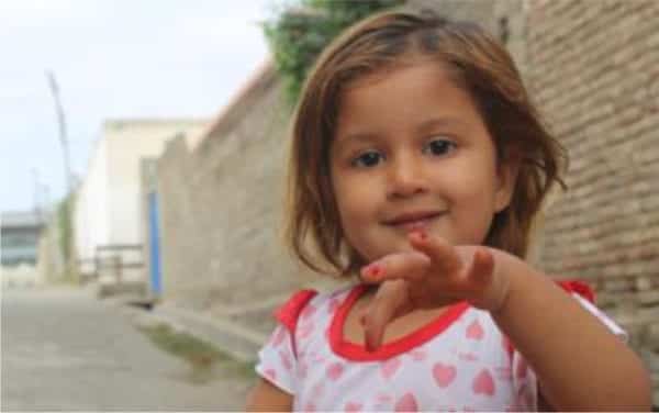 child shows off her newly painted finger nails